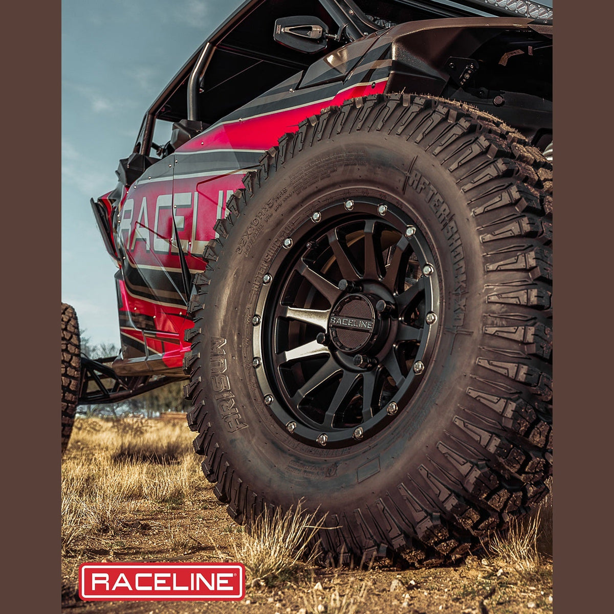 Matte black Raceline wheel mounted on red UTV with knobby tire