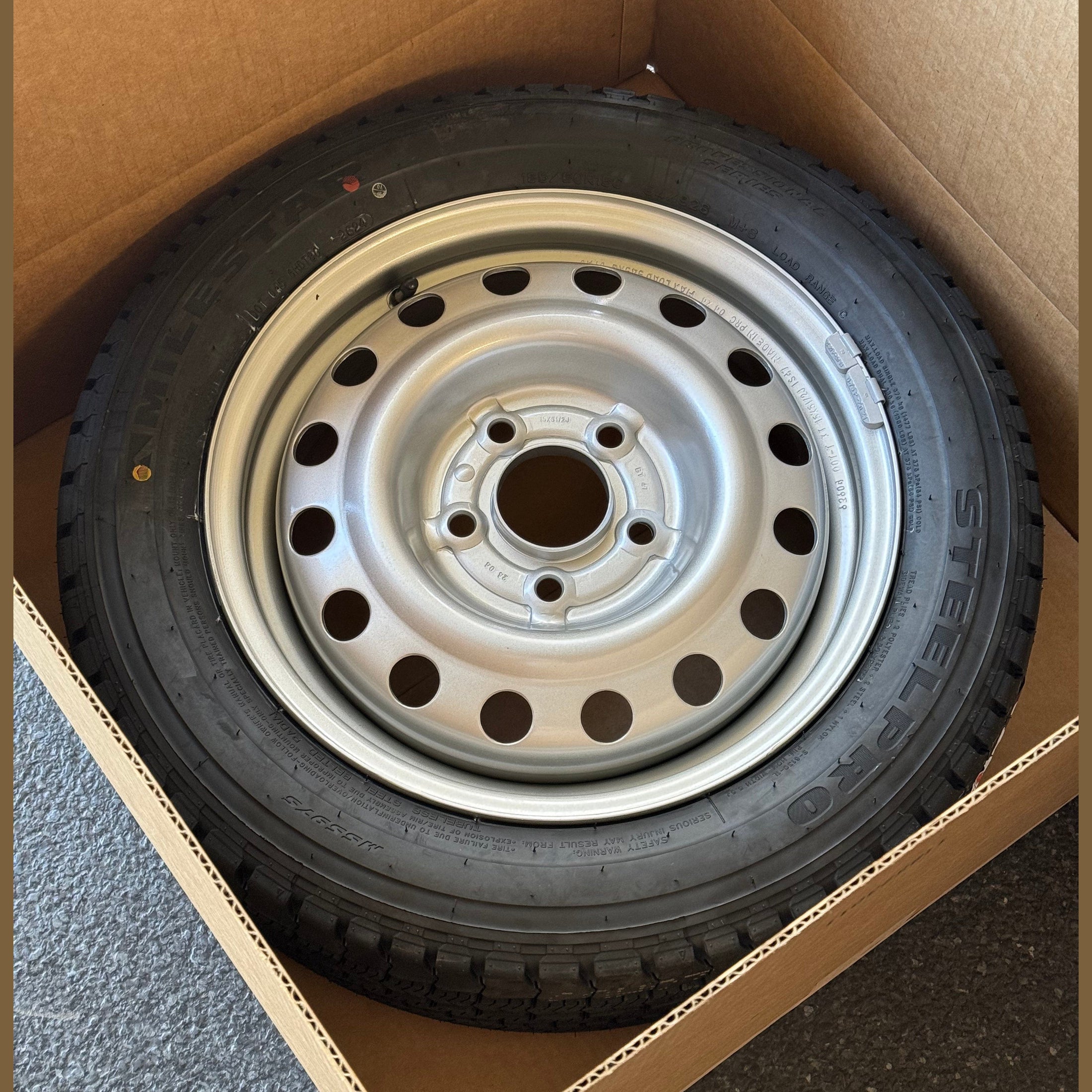 Nissan NV200 steel wheel and tire assembly in box with TPMS sensor
